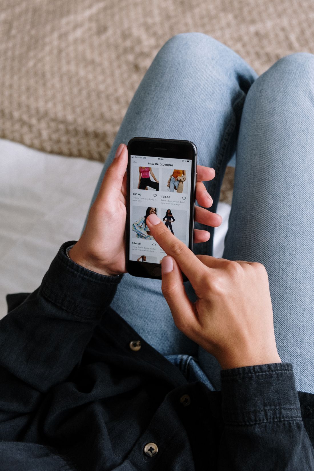 Person scrolling a grid of options on a phone the way patients now compare doctors before booking
