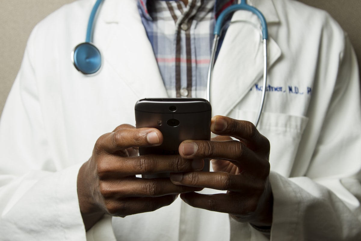A person holding a phone, the way most patients with no regular doctor begin the search for a new primary care practice