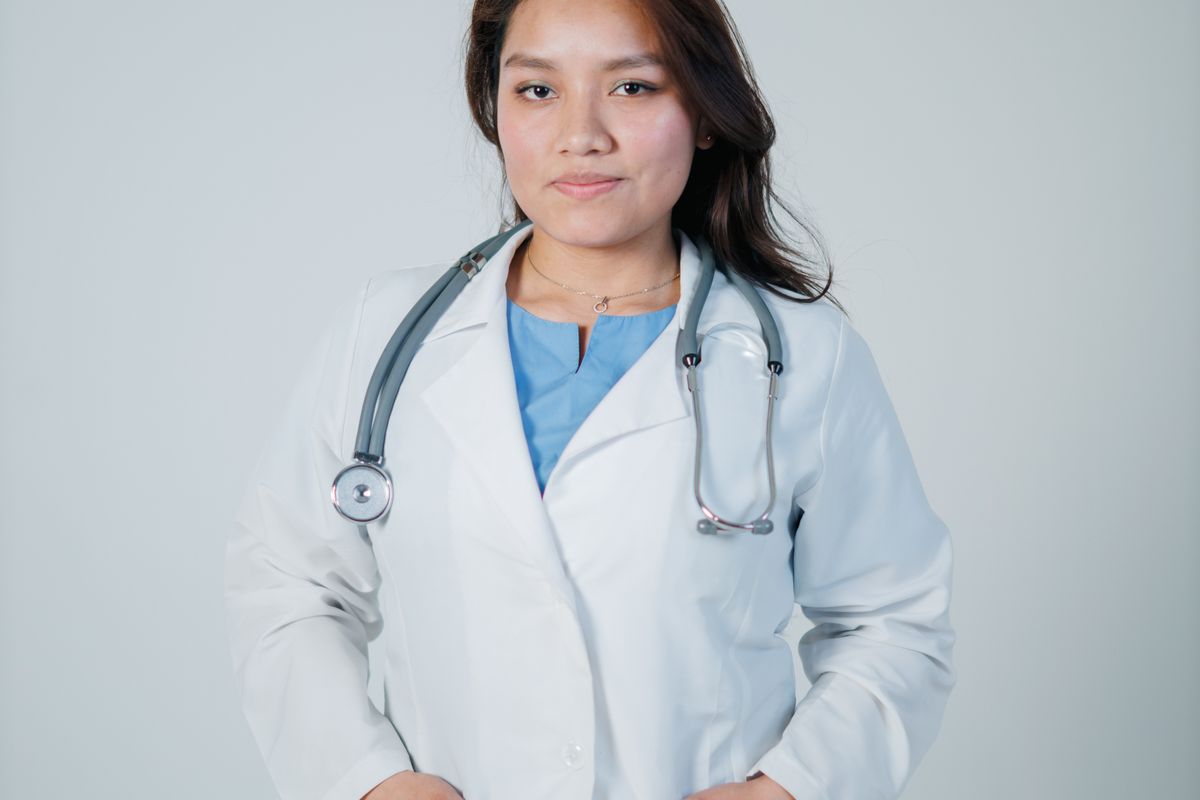 A doctor in a white coat and stethoscope, the kind of real headshot that belongs on a provider's own page