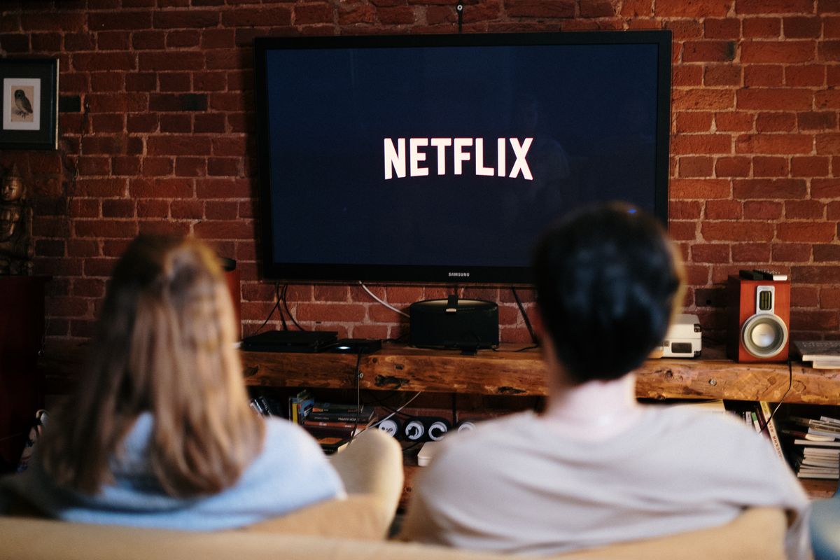 A couple watching video on their living room TV, where more than half of YouTube viewing now happens and where YouTube ads for medical practices can reach local patients
