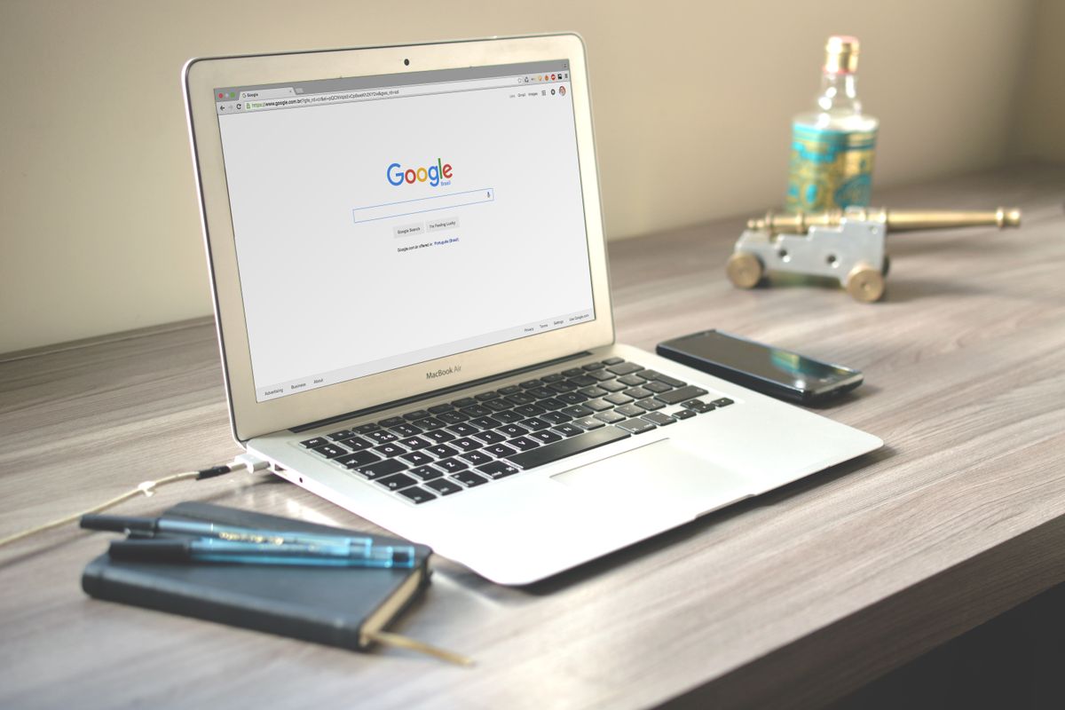 A laptop open to Google search on a desk, where a patient might type a competitor medical practice name