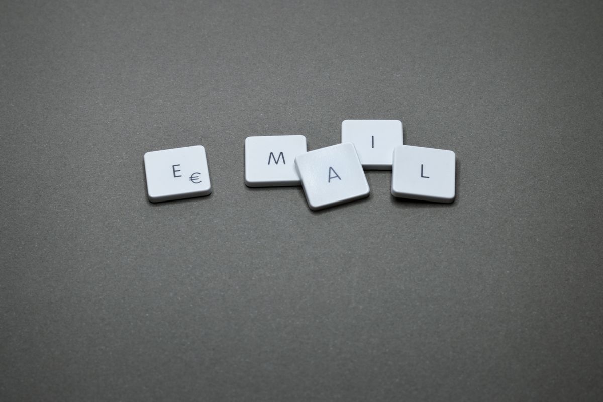 White keycaps spelling the word email on a gray desk, illustrating whether a medical practice should buy a patient email list