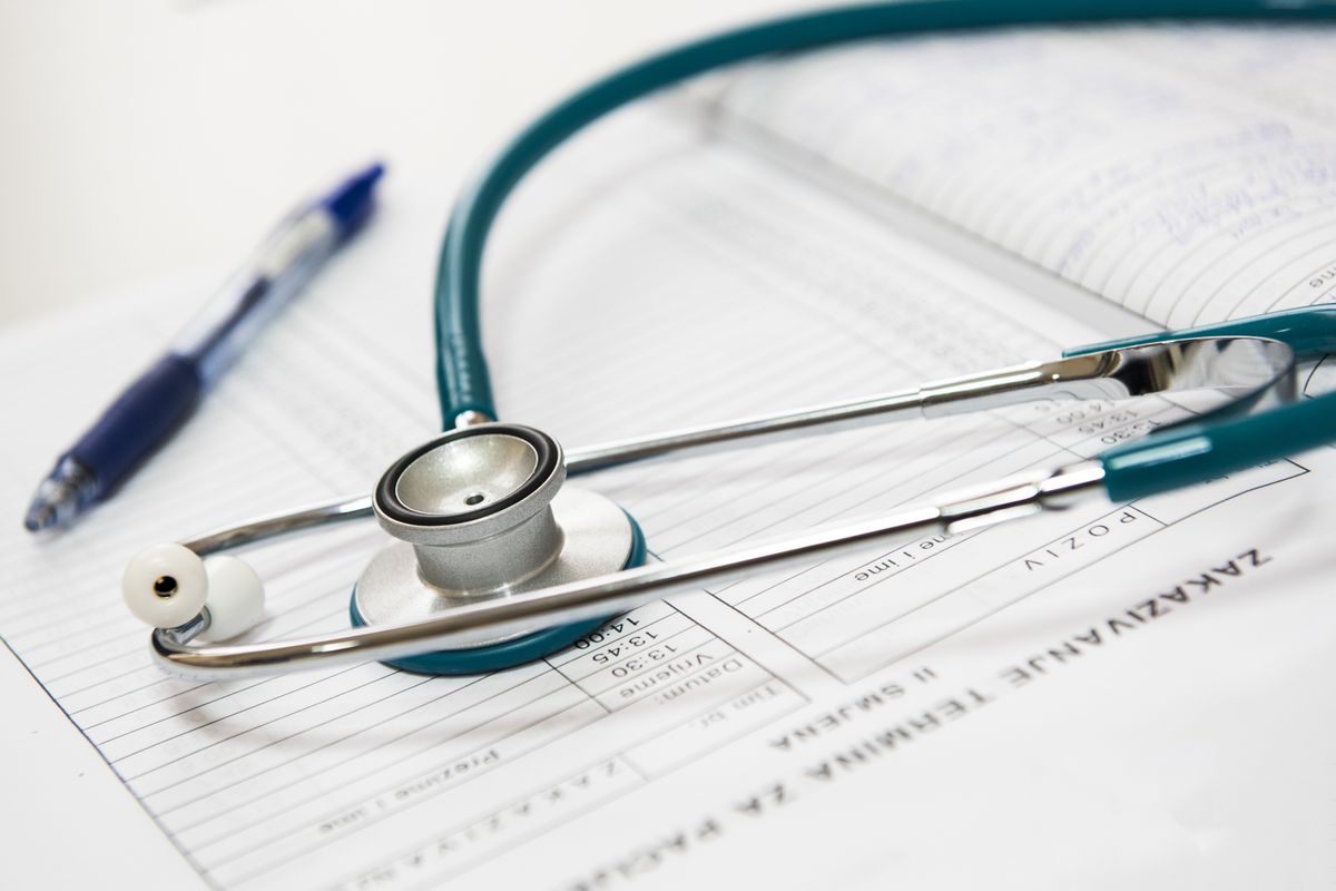 A stethoscope resting on a medical appointment scheduling form, illustrating the walk in versus scheduled appointment question for a medical practice