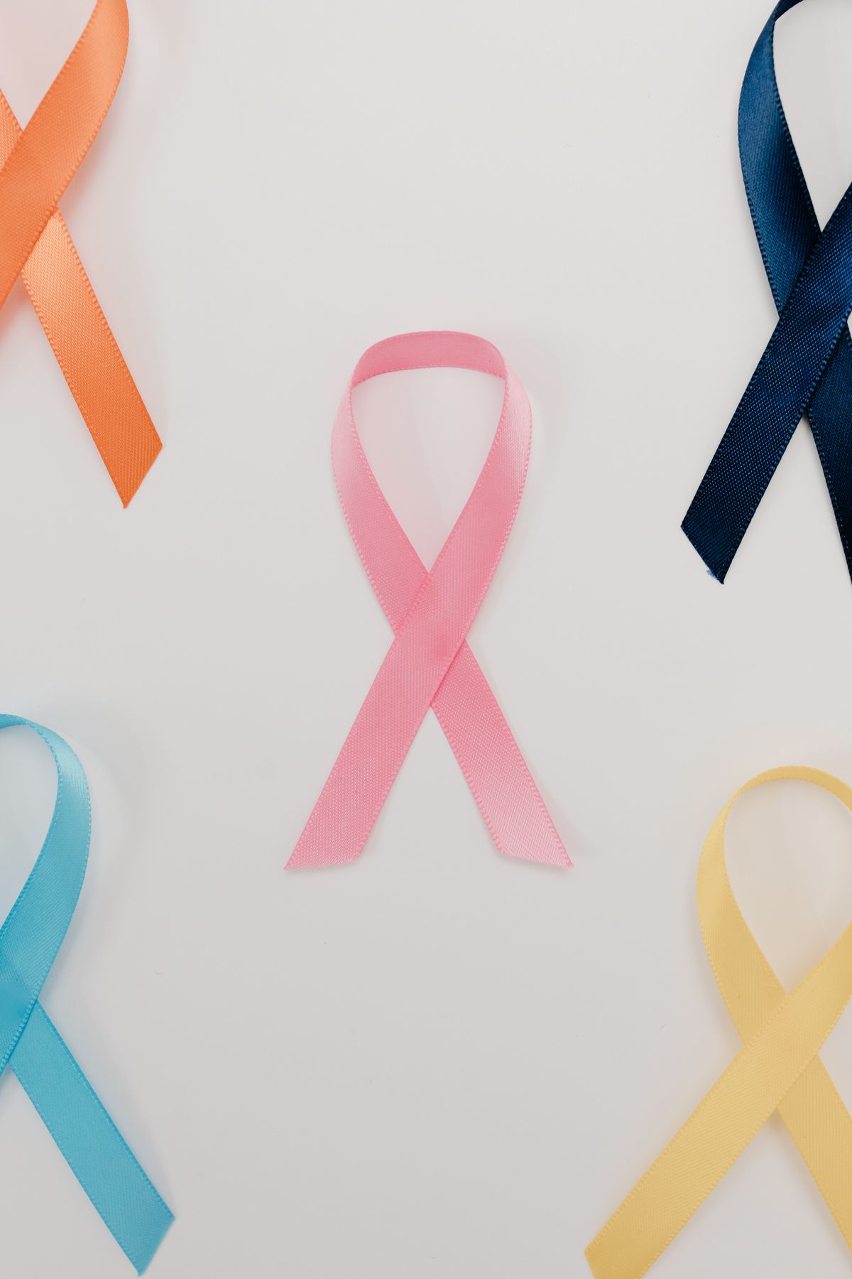 Colored awareness ribbons for different health causes laid on a white background, representing health awareness months