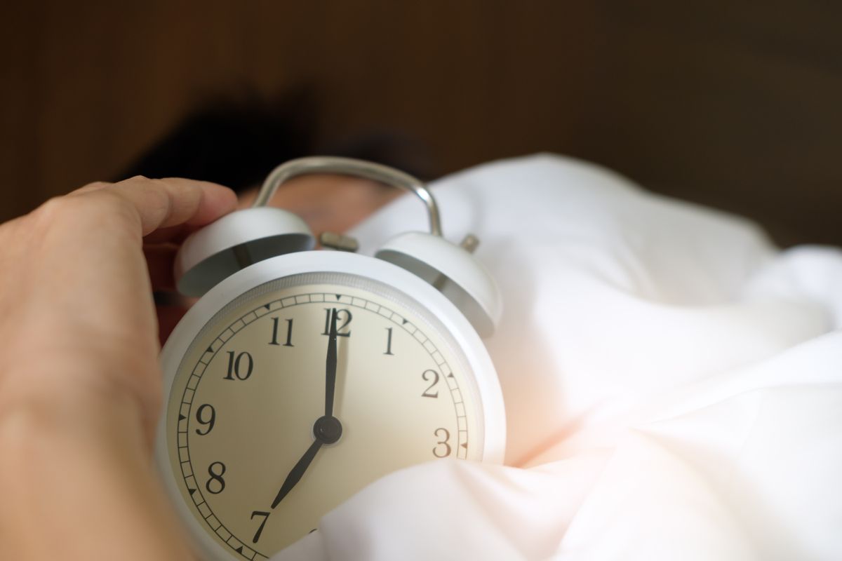 An alarm clock at night, a reminder that Google Ads keep spending around the clock unless a medical practice sets an ad schedule