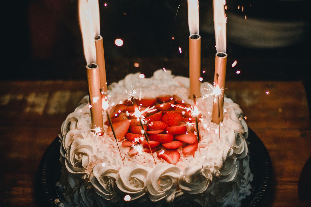 A birthday cake with lit sparklers, the kind of personal moment a patient birthday message taps into
