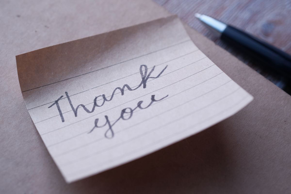 A handwritten thank you note on paper with a pen, the kind a medical practice can send patients after a visit