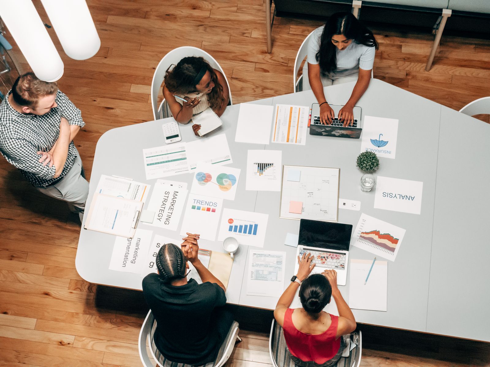 A medical practice marketing team reviewing strategy, trends, and analysis on a table instead of chasing viral views