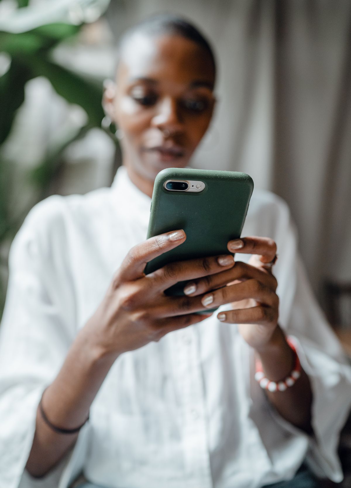 A patient pulling out a phone to scan a QR code and book a medical appointment
