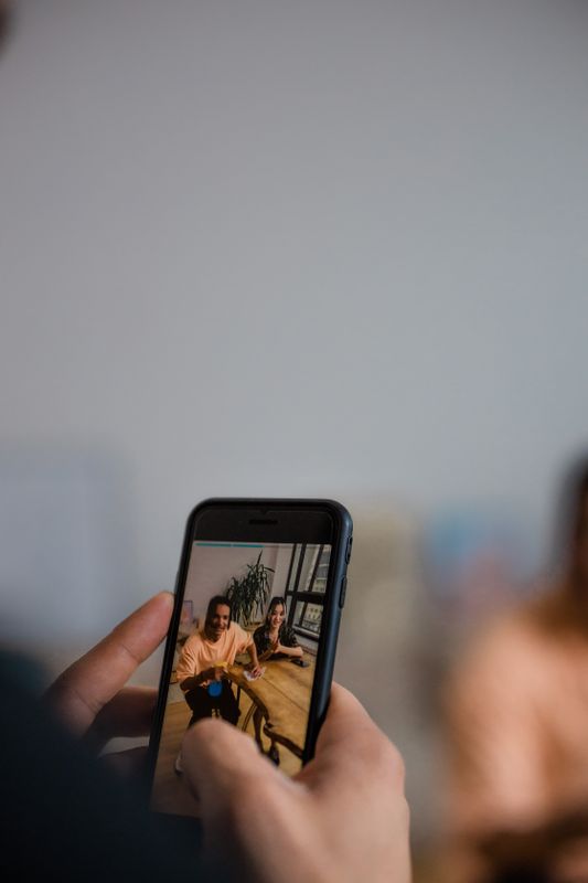 Close up of a person filming a short vertical video on a smartphone, the kind of clip a medical practice can post to its Google Business Profile