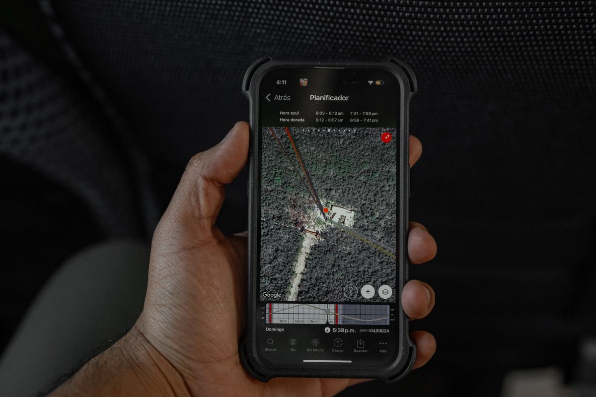 A patient holding a phone showing a Google map with directions while trying to find a medical practice