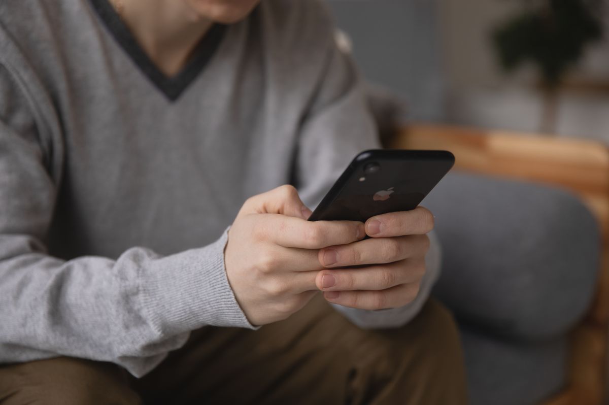 A patient searching for a doctor and specific treatment on a phone, the kind of near me search a full Google Business Profile services list helps you match