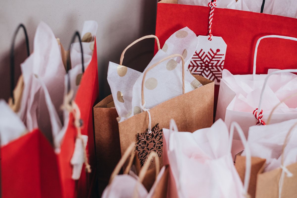 Red and brown holiday gift bags with snowflake tags, representing the holiday season when a medical practice needs to update its Google hours