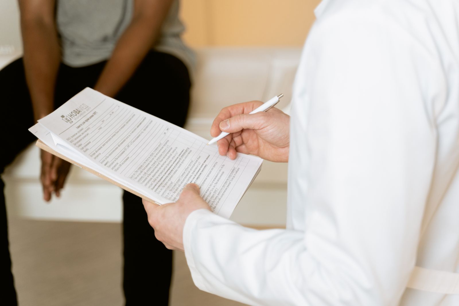 A healthcare provider reviewing insurance paperwork with a patient at a medical practice
