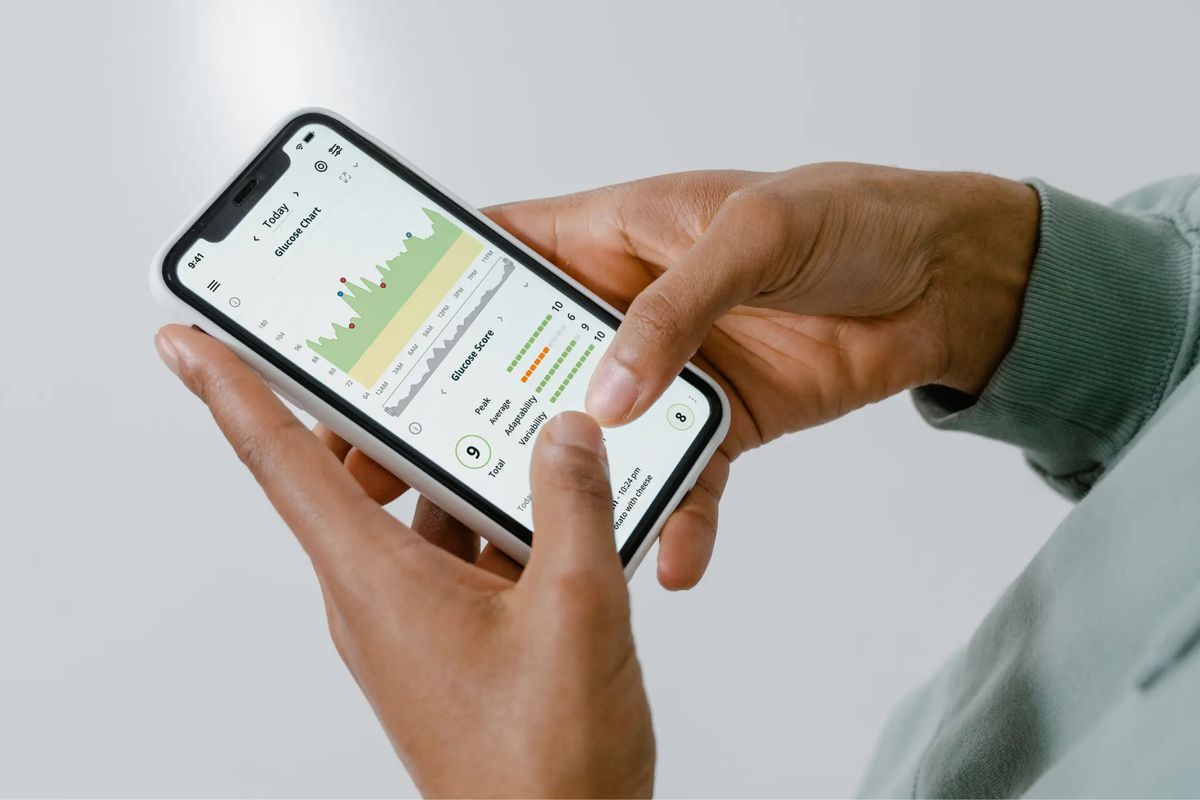 A patient checking a health app and their own data on a smartphone before booking a medical appointment