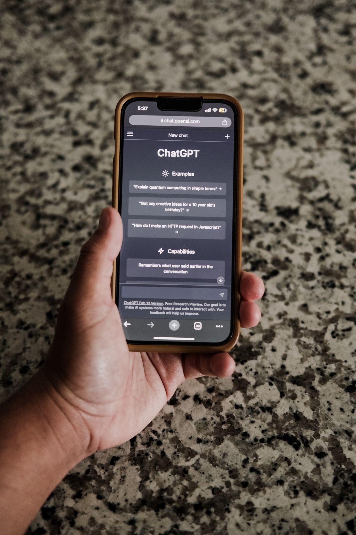 A patient holding a phone with ChatGPT open, researching a doctor before booking