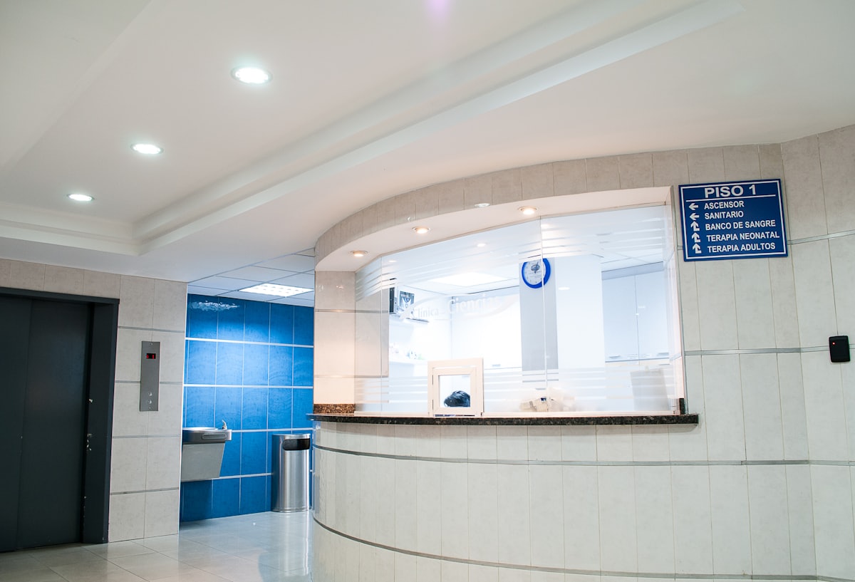A doctor in a white coat walking down a hospital corridor, the moment a provider leaves a medical practice and the patient panel is at risk