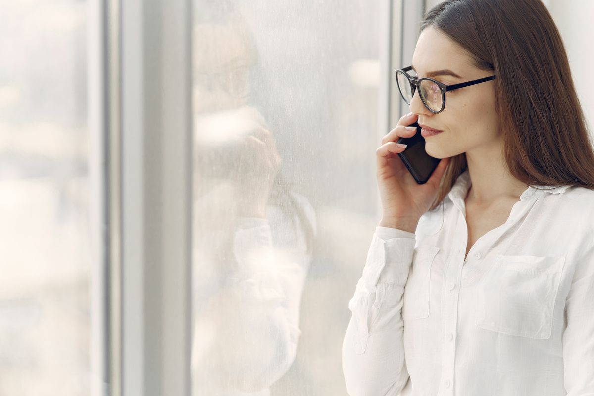 A patient waiting on hold on a phone call with a medical practice, deciding whether to keep waiting or hang up