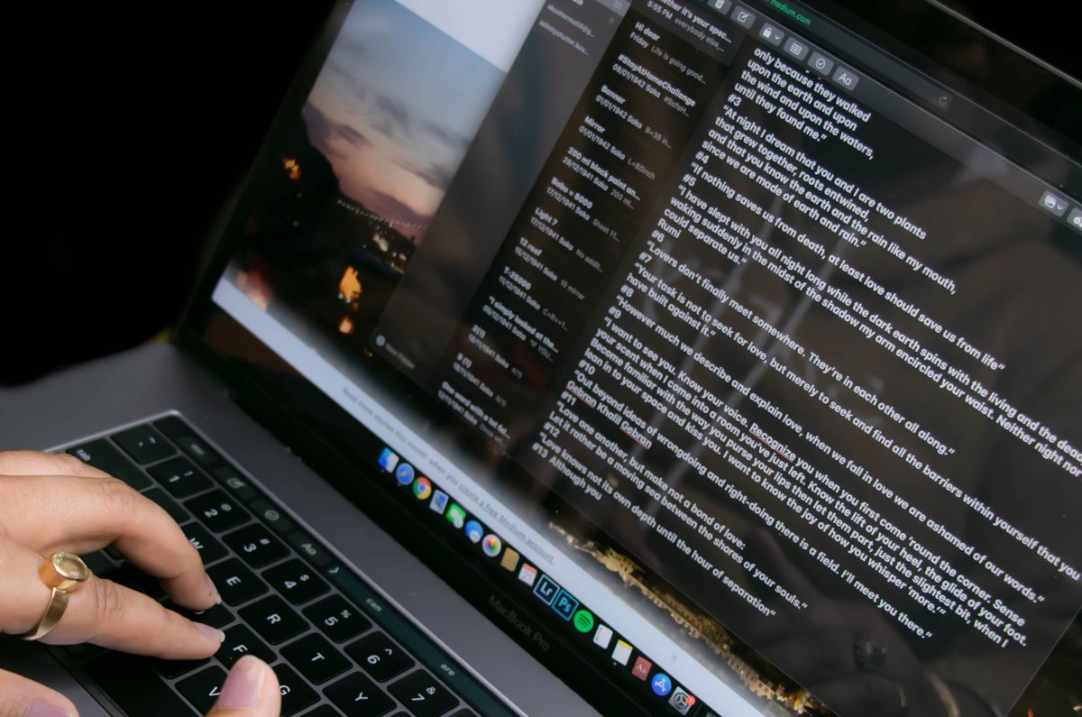 A person typing a new patient welcome email on a laptop, the first message a medical practice sends after someone books