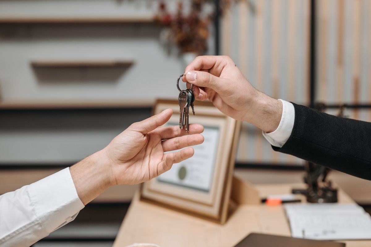 One hand passing a set of keys to another, representing who really holds the keys to a medical practice's marketing accounts
