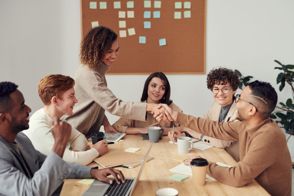 A team reviewing marketing charts and analytics around a table, the kind of marketing ownership most medical practices are missing