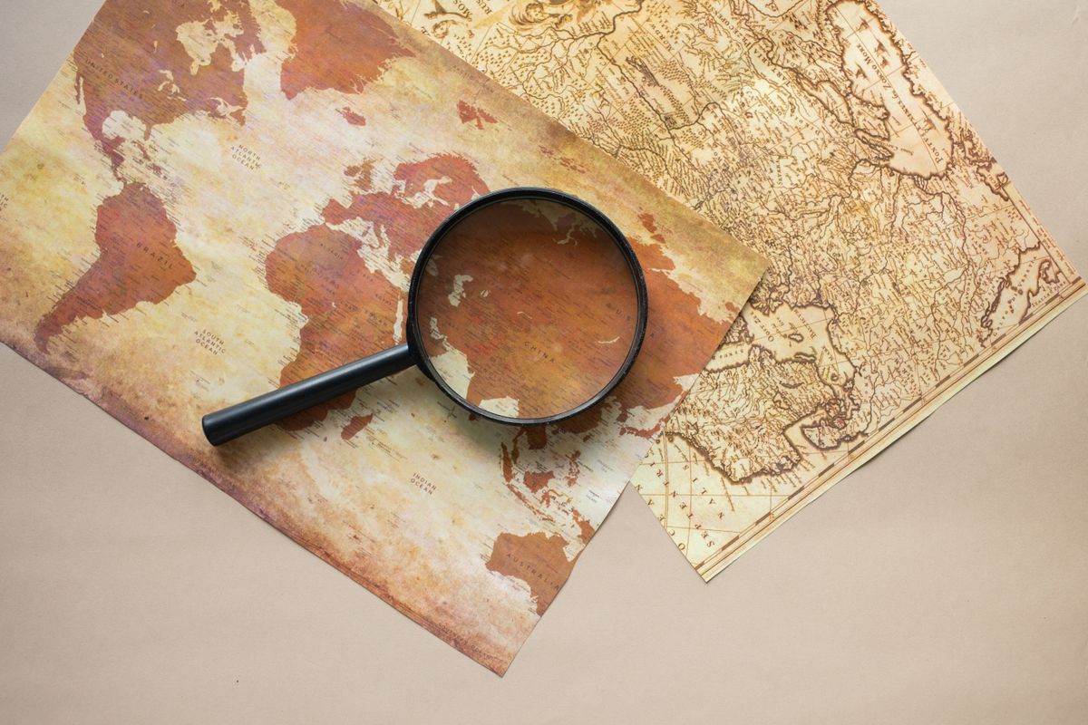 A magnifying glass over a map, showing how Google Ads location targeting decides which cities see a medical practice ad