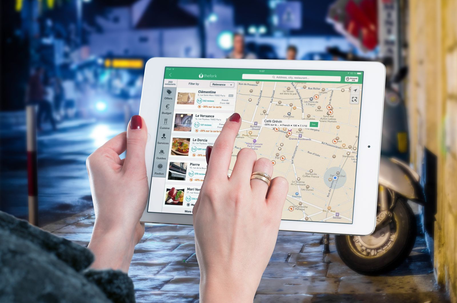 A person holding a tablet showing a map, searching for a local business the way patients search for a doctor