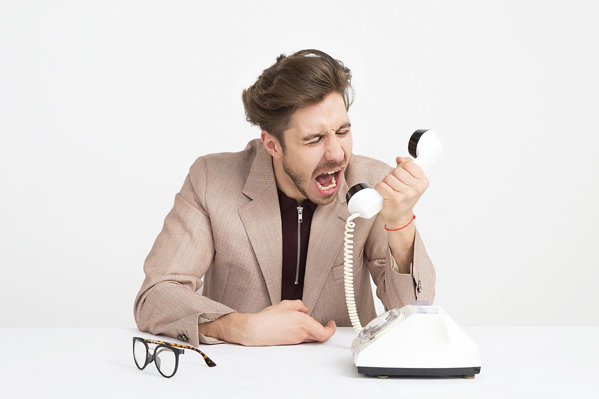 Frustrated medical practice staffer calling a patient back who will not answer the phone