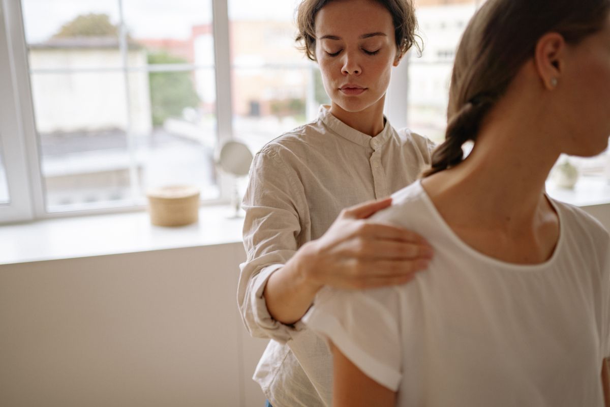 A physical therapist working with a patient during a treatment session, the kind of visit many patients quit before completing their full plan