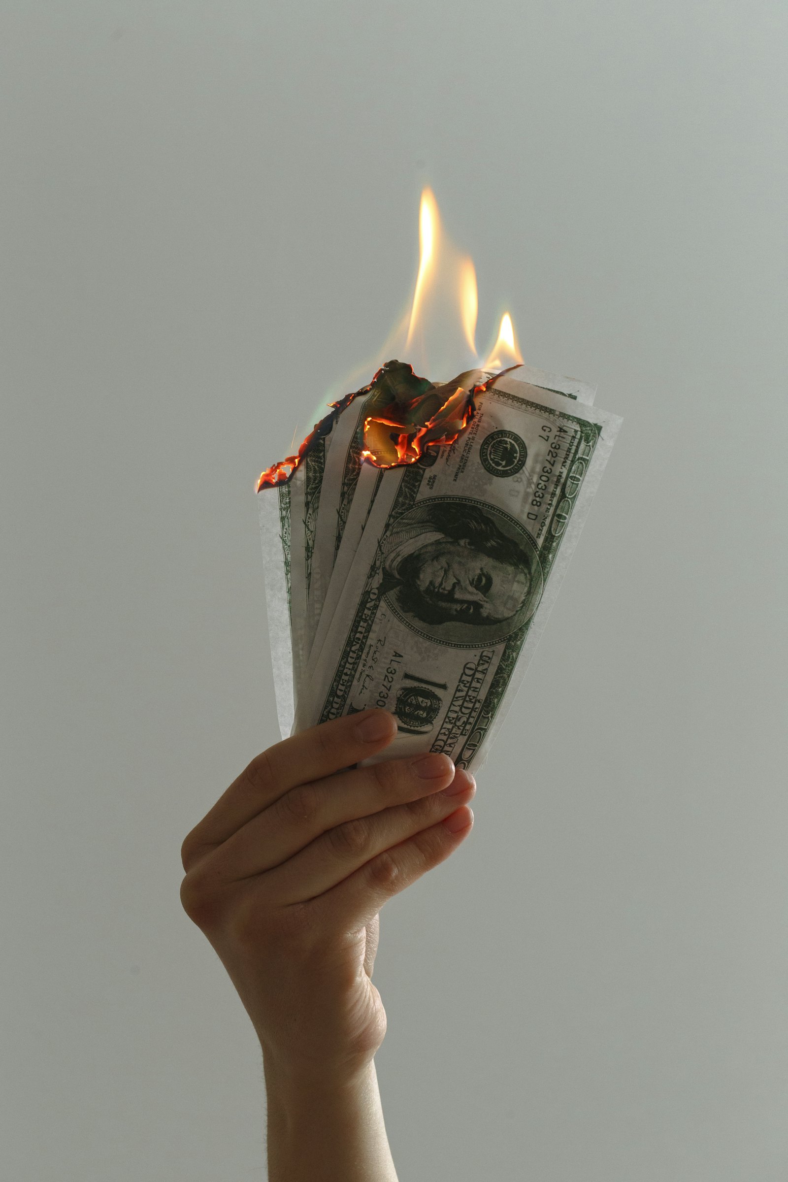 US dollar bills on fire, representing a medical practice ad budget burning without more patients to show for it