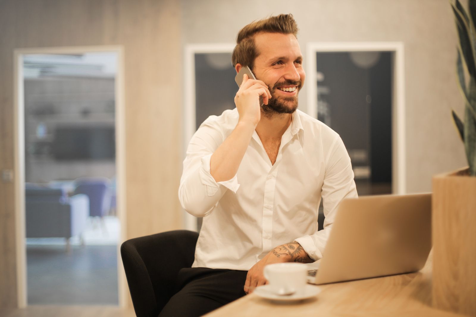 A patient smiling while on a phone call with a medical practice that answered right away, the goal of a good AI receptionist